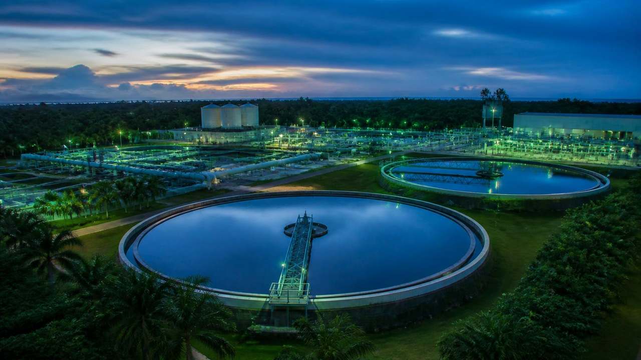 Anaerobic digesters, solar array and water reclamation clarifiers on the Eden Ghana campus